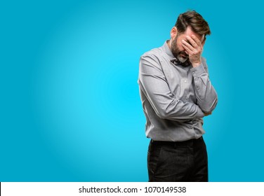 Middle age man, with beard and bow tie stressful keeping hands on head, tired and frustrated