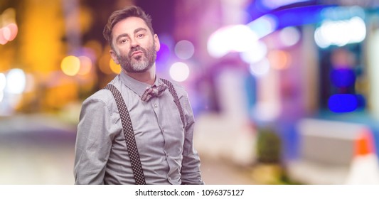 Middle Age Man, With Beard And Bow Tie Expressing Love, Blows Kiss At Camera, Flirting At Night Club