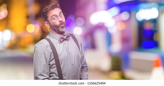 Middle Age Man, With Beard And Bow Tie Expressing Love, Blows Kiss At Camera, Flirting At Night Club