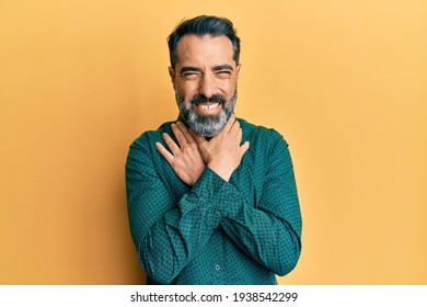 Middle age man with beard and grey hair wearing business clothes shouting and suffocate because painful strangle. health problem. asphyxiate and suicide concept. 