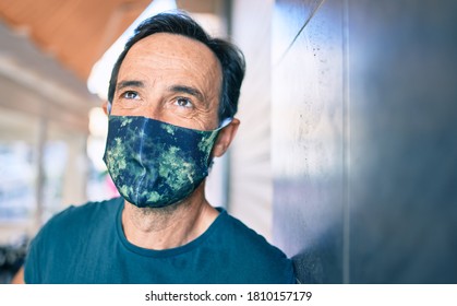 Middle age man with beard wearing coronavirus safety mask - Powered by Shutterstock