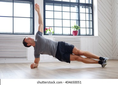 Middle Age Man Doing Fitness Workouts At Home.