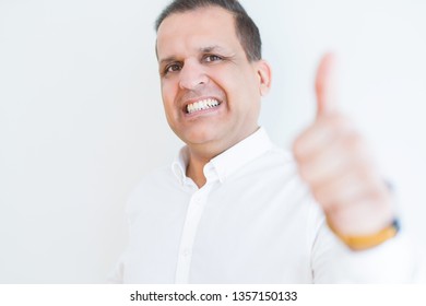 Middle age man doing postive gesture with thumbs up smiling to the camera