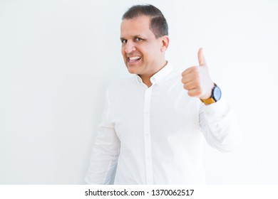 Middle age man doing postive gesture with thumbs up smiling to the camera