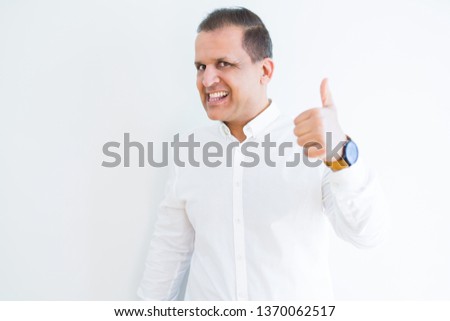 Middle age man doing postive gesture with thumbs up smiling to the camera