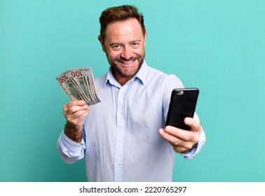 middle age man with dollar banknotes. online shopping concept sport coach concept with a soccer ball - Powered by Shutterstock