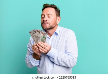 middle age man with dollar banknotes sport coach concept with a soccer ball - Powered by Shutterstock