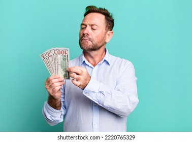 middle age man with dollar banknotes sport coach concept with a soccer ball - Powered by Shutterstock