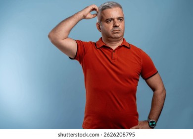 Middle age man with doubt expression, confuse and wonder concept, uncertain future isolated over blue background.