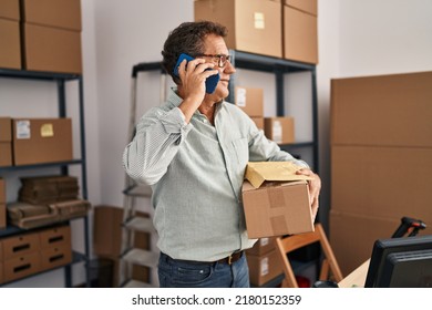 Middle Age Man Ecommerce Business Worker Talking On The Smartphone And Holding Package At Office