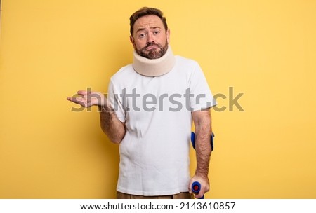 middle age man feeling puzzled and confused and doubting accident injured concept