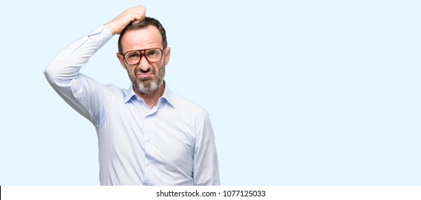 Middle Age Man With Glasses Doubt Expression, Confuse And Wonder Concept, Uncertain Future Isolated Over Blue Background