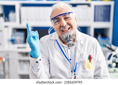 Middle Age Man With Grey Hair Working At Scientist Laboratory Smiling Happy Pointing With Hand And Finger To The Side 