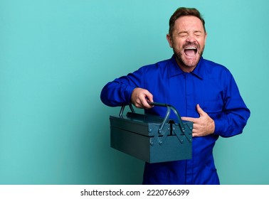 Middle Age Man Laughing Out Loud At Some Hilarious Joke. Plumber With A Toolbox Concept