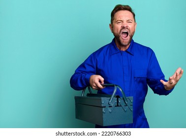 Middle Age Man Looking Angry, Annoyed And Frustrated. Plumber With A Toolbox Concept