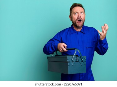 Middle Age Man Looking Desperate, Frustrated And Stressed. Plumber With A Toolbox Concept