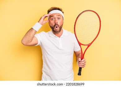 Middle Age Man Looking Happy, Astonished And Surprised. Tennis Concept