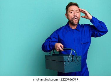 Middle Age Man Looking Happy, Astonished And Surprised. Plumber With A Toolbox Concept