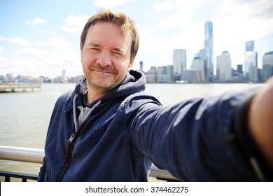 Middle Age Man Making A Self Portrait (selfie) With Manhattan Skyscrapers In New York City
