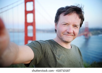 Middle Age Man Making A Self Portrait (selfie) With Famous Golden Gate Bridge In San Francisco, California, USA