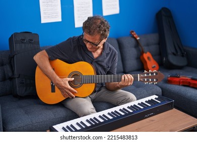 Middle Age Man Musician Playing Classical Guitar At Music Studio