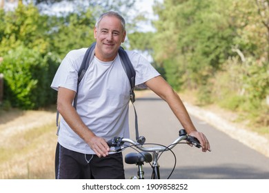 Middle Age Man On A Bike