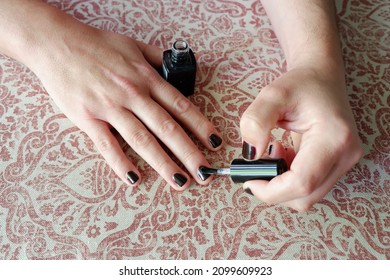 Middle Age Man Painting Nails In Black Colour At Home In Madrid, Spain. Concepts Of Male Makeup And Self Care