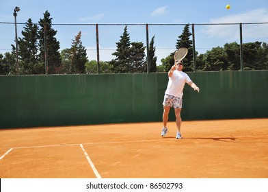 Middle Age Man Playing Tennis