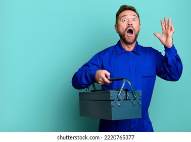 Middle Age Man Screaming With Hands Up In The Air. Plumber With A Toolbox Concept