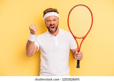 Middle Age Man Shouting Aggressively With An Angry Expression. Tennis Concept