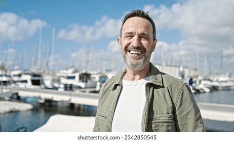 Middle age man smiling confident standing at port - Powered by Shutterstock