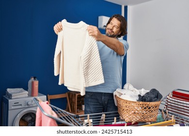 Middle age man smiling confident hanging clothes on clothesline at laundry room - Powered by Shutterstock