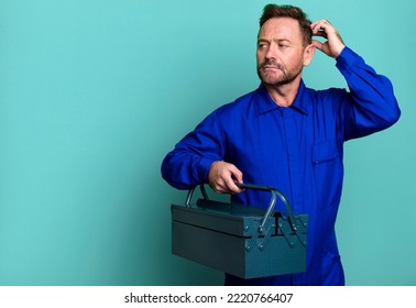 Middle Age Man Smiling Happily And Daydreaming Or Doubting. Plumber With A Toolbox Concept