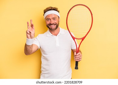 Middle Age Man Smiling And Looking Friendly, Showing Number Three. Tennis Concept