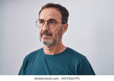 Middle age man standing with serious expression over isolated white background - Powered by Shutterstock