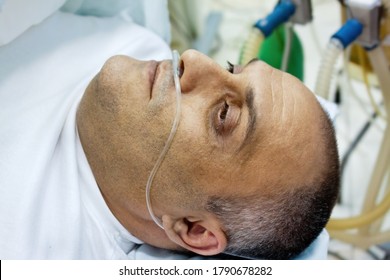 Middle Age Man In The Surgery Room Hooked On Oxygen Tubes