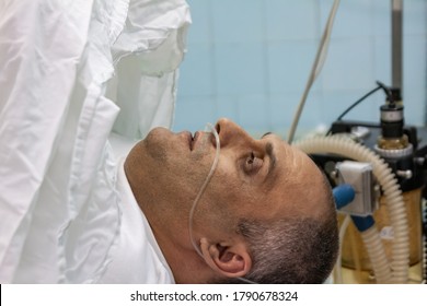 Middle Age Man In The Surgery Room Hooked To Oxygen Tubes And Machinery Preparing  For A Surgery