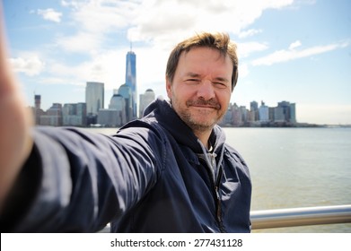 Middle Age Man Taking A Self Portrait (selfie) With Manhattan Skyscrapers In New York City