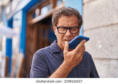 Middle age man talking on the smartphone at street - Powered by Shutterstock