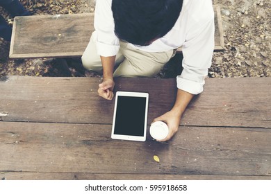 Middle age man using smart tablet to explore website.