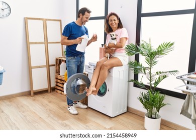 Middle Age Man And Woman Couple Smiling Confident And Hugging Dog Washing Clothes At Laundry Room