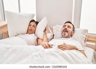 Middle Age Man And Woman Couple Unhappy For Snoring At Bedroom