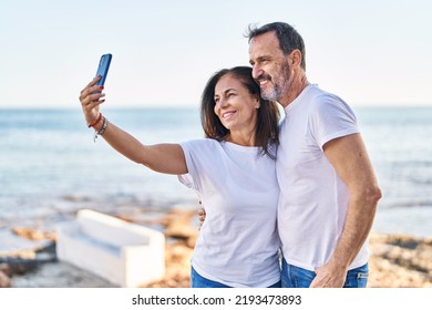 Middle age man and woman couple make selfie by the smartphone at seaside - Powered by Shutterstock