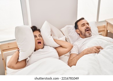 Middle Age Man And Woman Couple Unhappy For Snoring At Bedroom