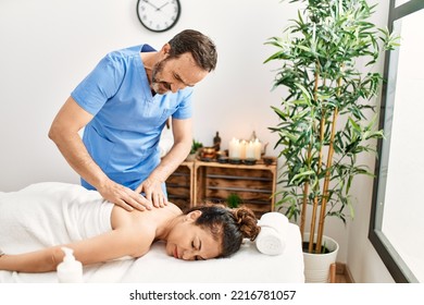 Middle Age Man And Woman Wearing Therapist Uniform Having Back Massage Session At Beauty Center