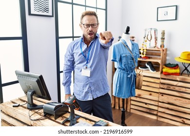 Middle Age Man Working As Manager At Retail Boutique Pointing Displeased And Frustrated To The Camera, Angry And Furious With You 