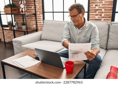 Middle age man working using laptop at home - Powered by Shutterstock