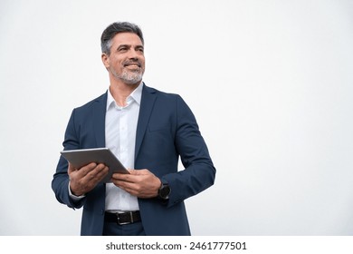 Middle age mature businessman using pc tablet for business work application. Smiling handsome older man in formal suit holding touchscreen device looking aside. Isolated white background, copy space - Powered by Shutterstock