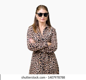 Middle Age Mature Rich Woman Wearing Sunglasses And Leopard Dress Over Isolated Background Skeptic And Nervous, Disapproving Expression On Face With Crossed Arms. Negative Person.