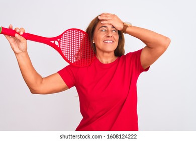 Middle Age Mature Woman Holding Red Tennis Racket Over Isolated Background Stressed With Hand On Head, Shocked With Shame And Surprise Face, Angry And Frustrated. Fear And Upset For Mistake.